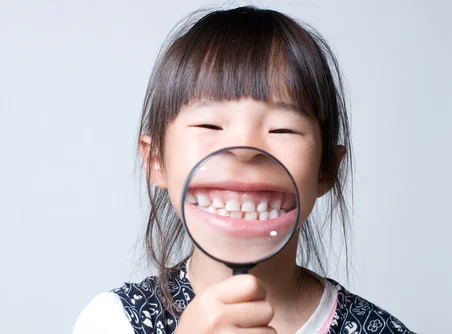 整った歯並びを見せて笑うお子さま